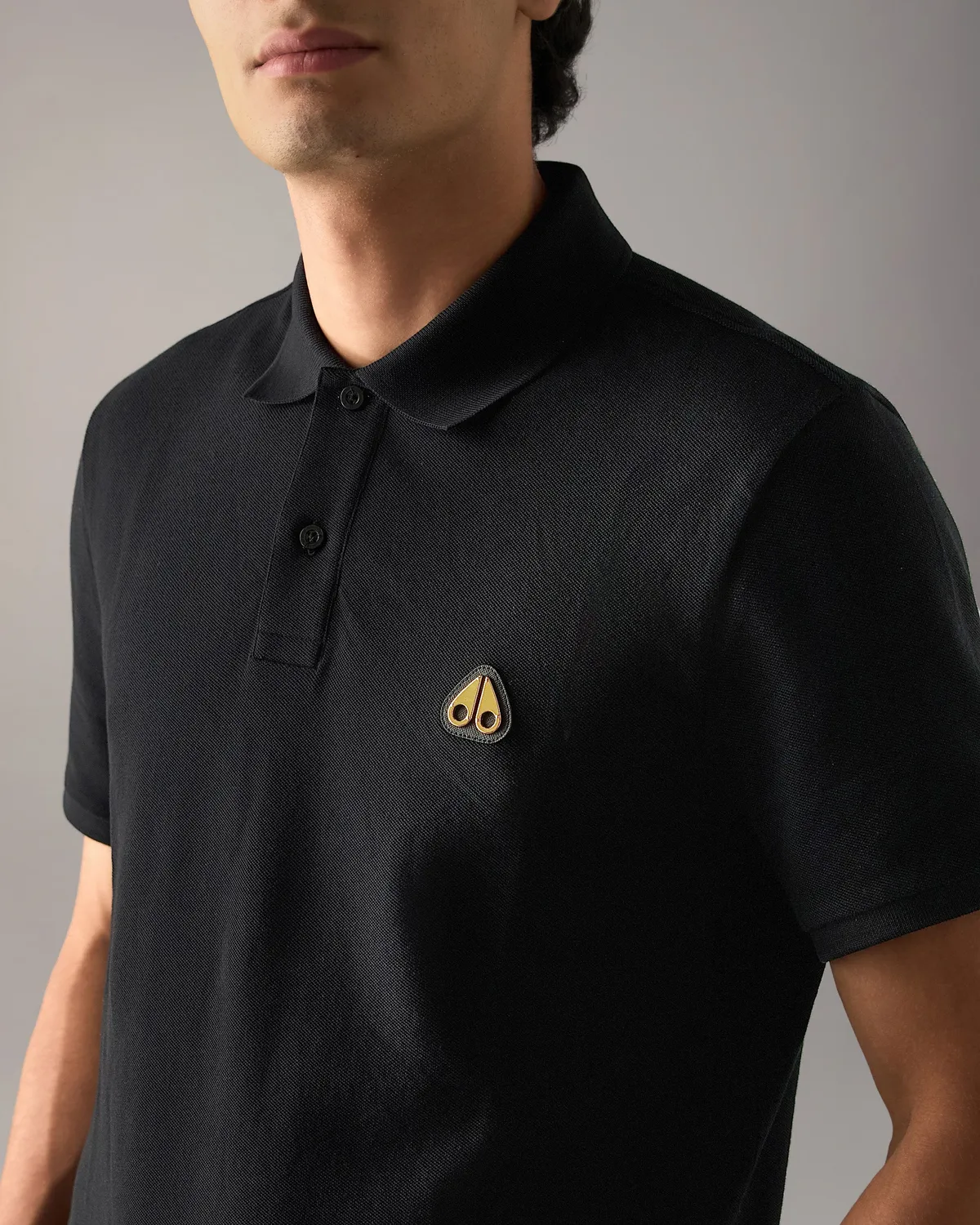 Moose Knuckles Gold Series Everett polo noir détails dorés